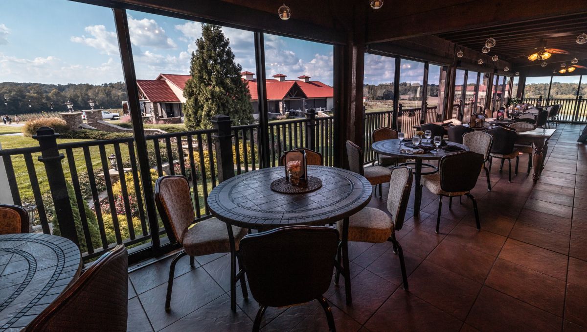 Patio with tables and chairs looking out onto Childress Vineyards