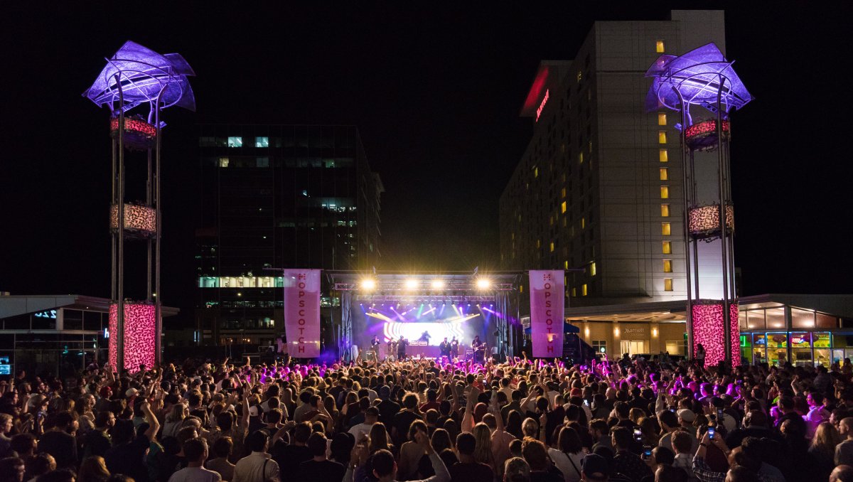 Huge crowd in front of concert stage in downtown Raleigh at night