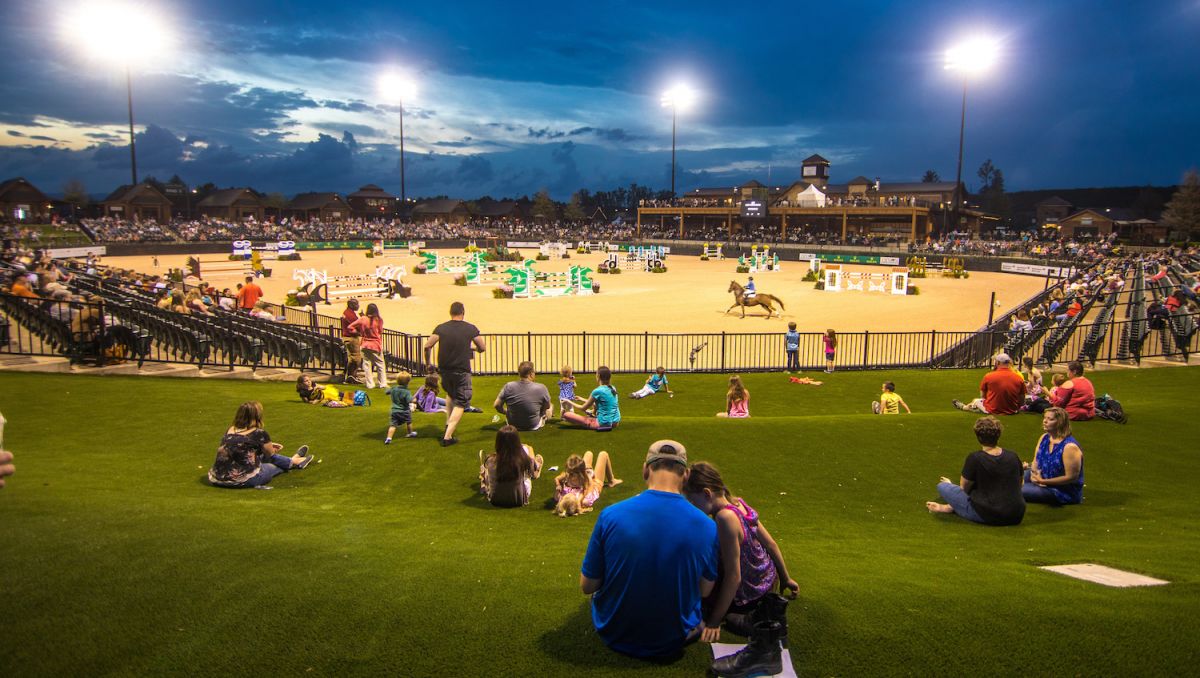 People sitting on lawn watching Tryon International Equestrian Center's Saturday Night Lights series