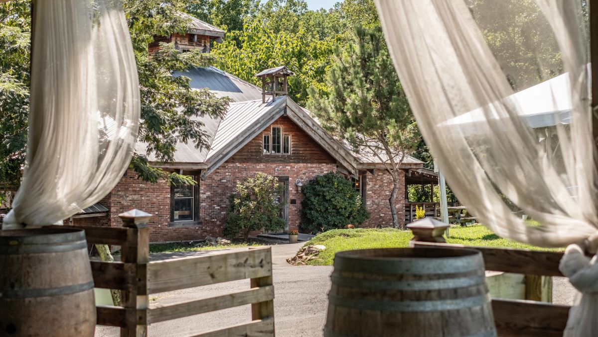 Vineyard tasting room with white sheer curtains and wine building